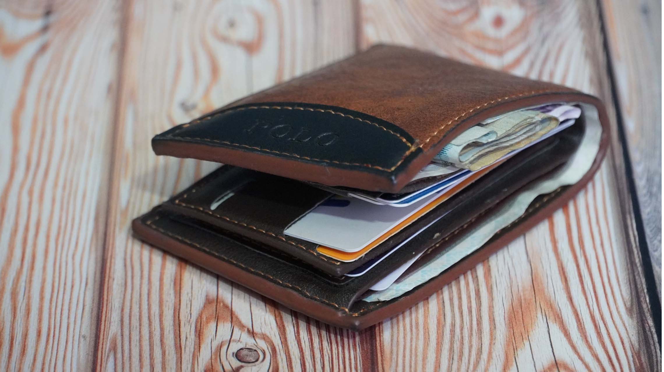 bulging wallet with papers impacted by CPI inflation